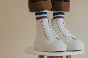 man-in-white-high-top-shoes-standing-on-chair.jpg